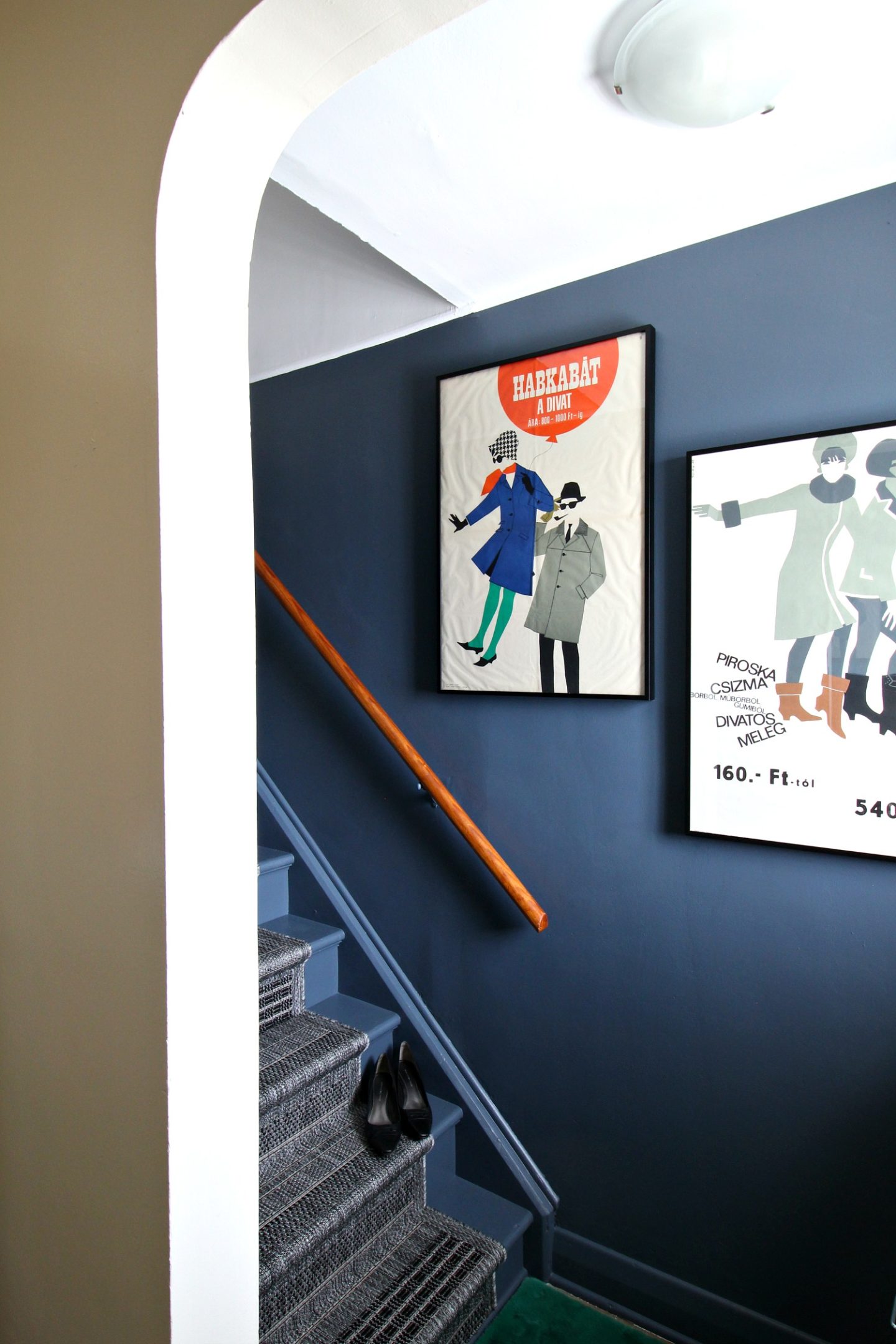 Vintage Entryway Decor with Mid-Century Posters and Dark Grey Walls 