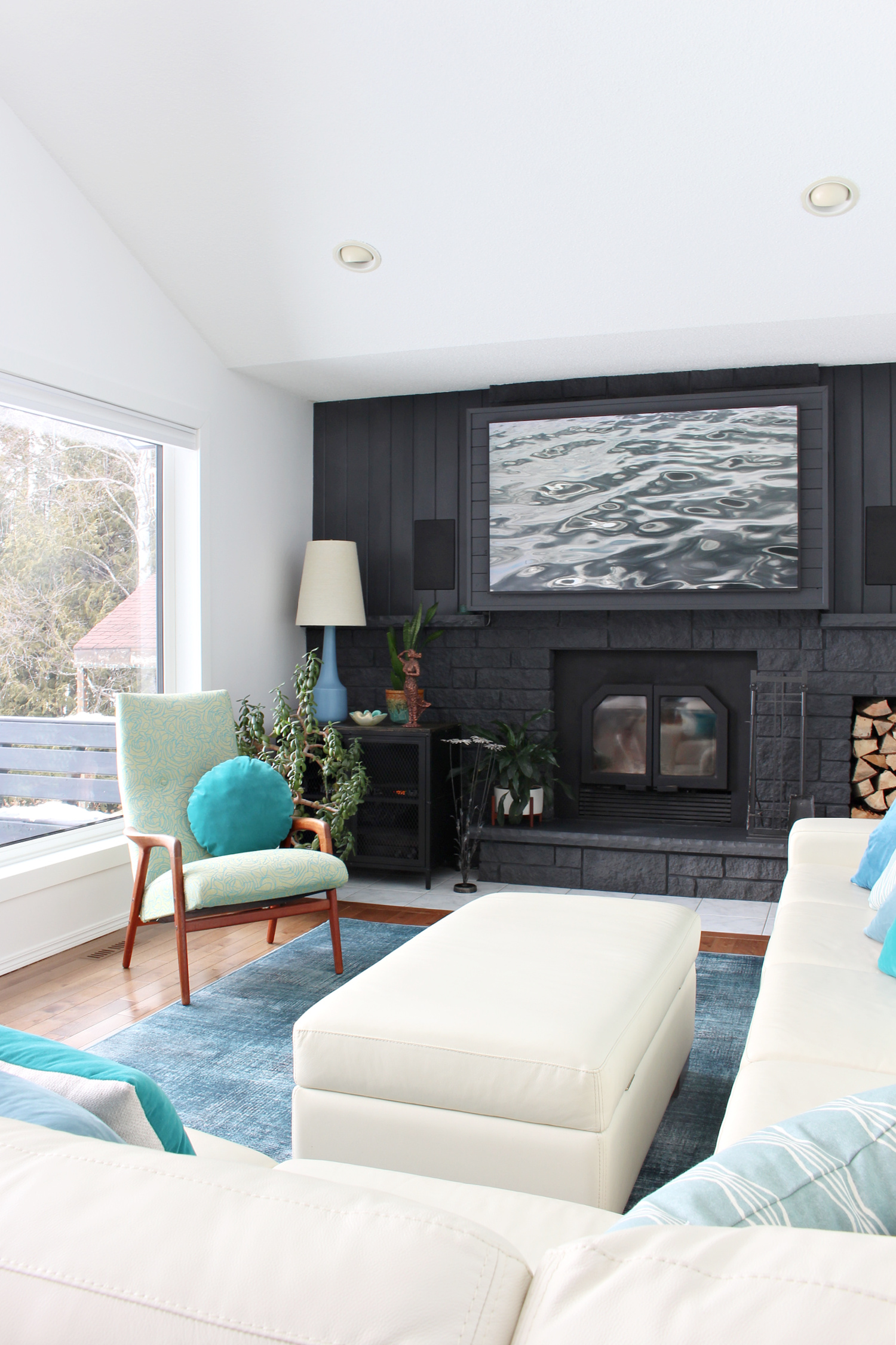 Black Fireplace with Cream Sofa and Teal Accents