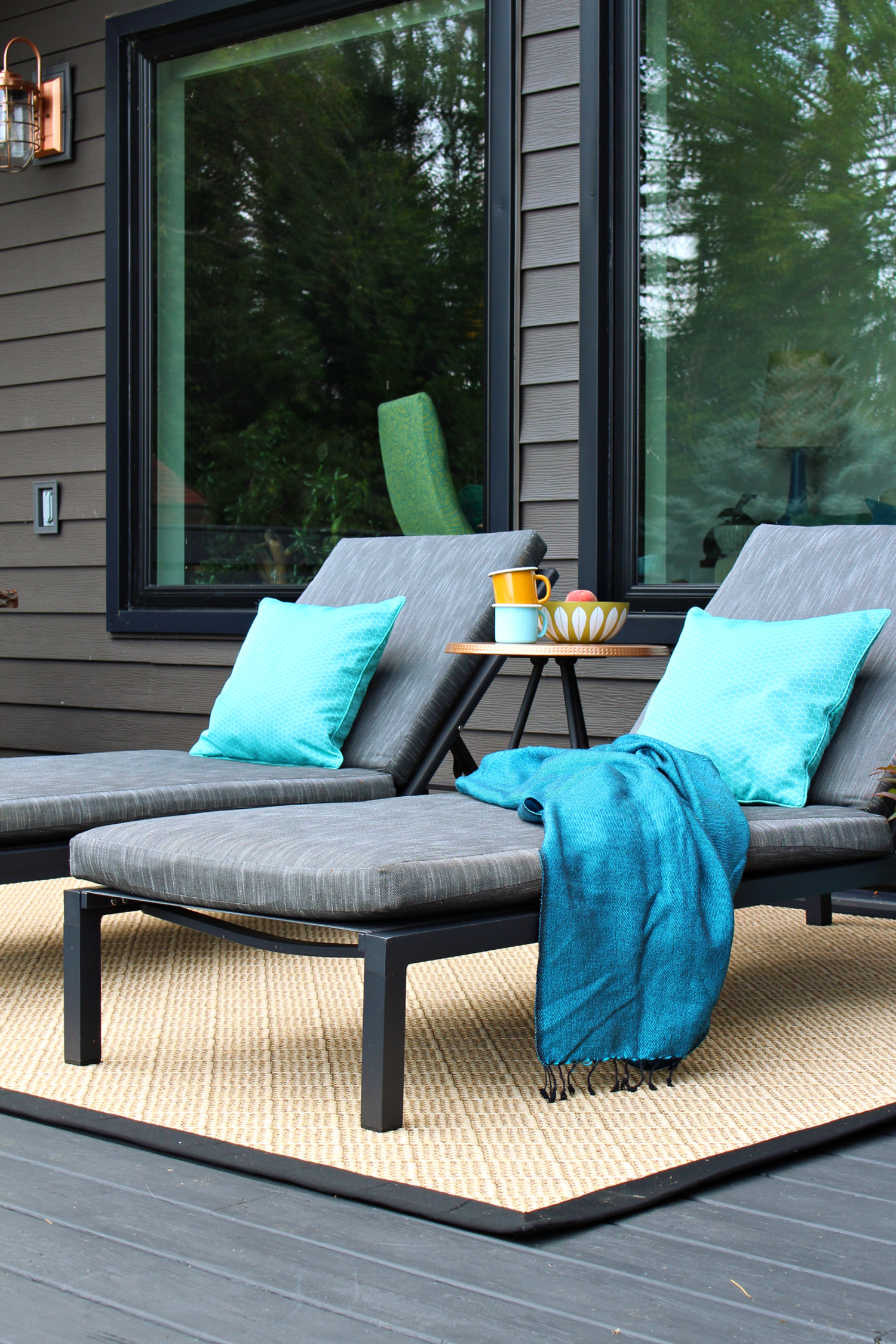 Black Patio Loungers and Natural Outdoor Rug